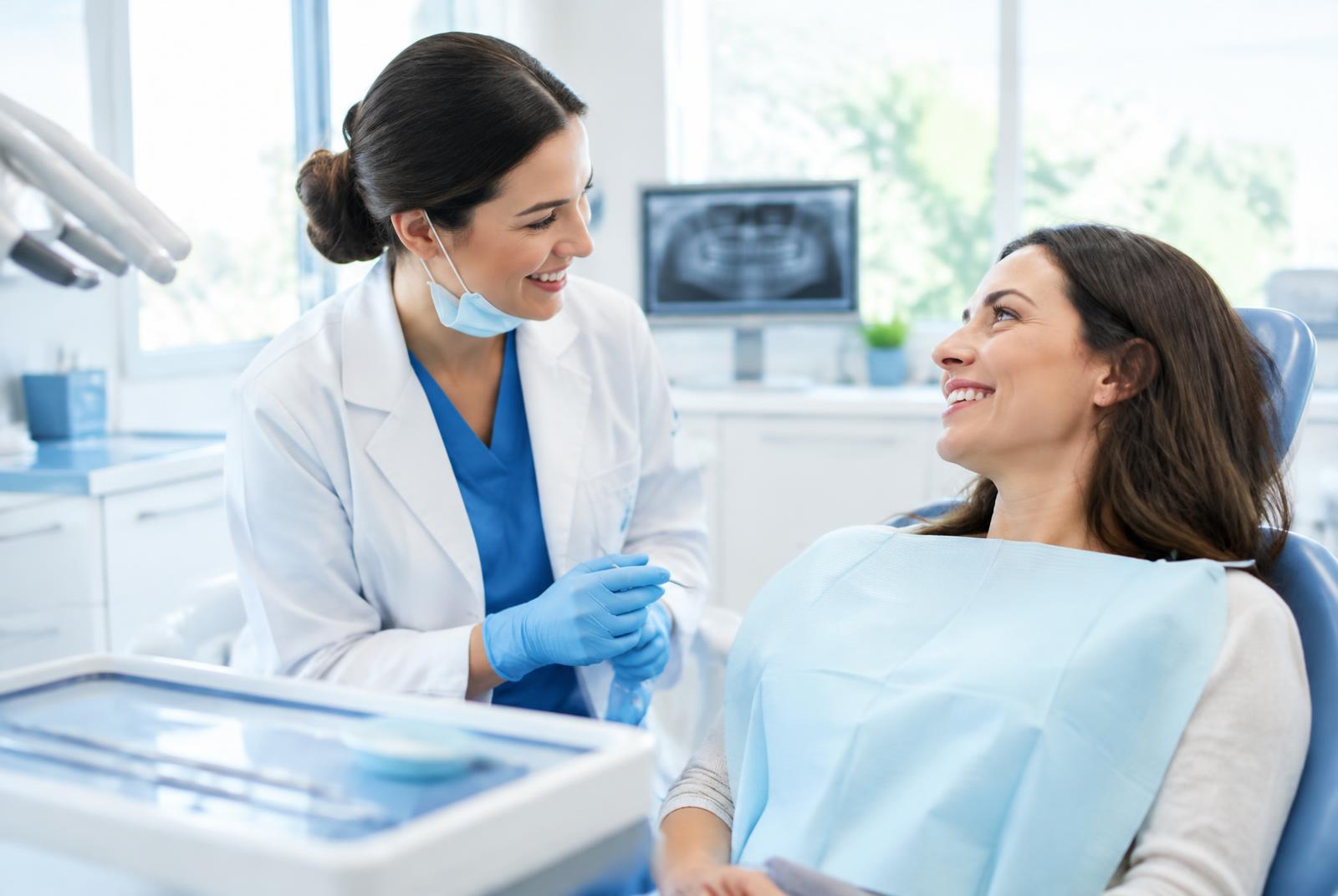 A dentist and patient in conversation in a bright, modern clinic